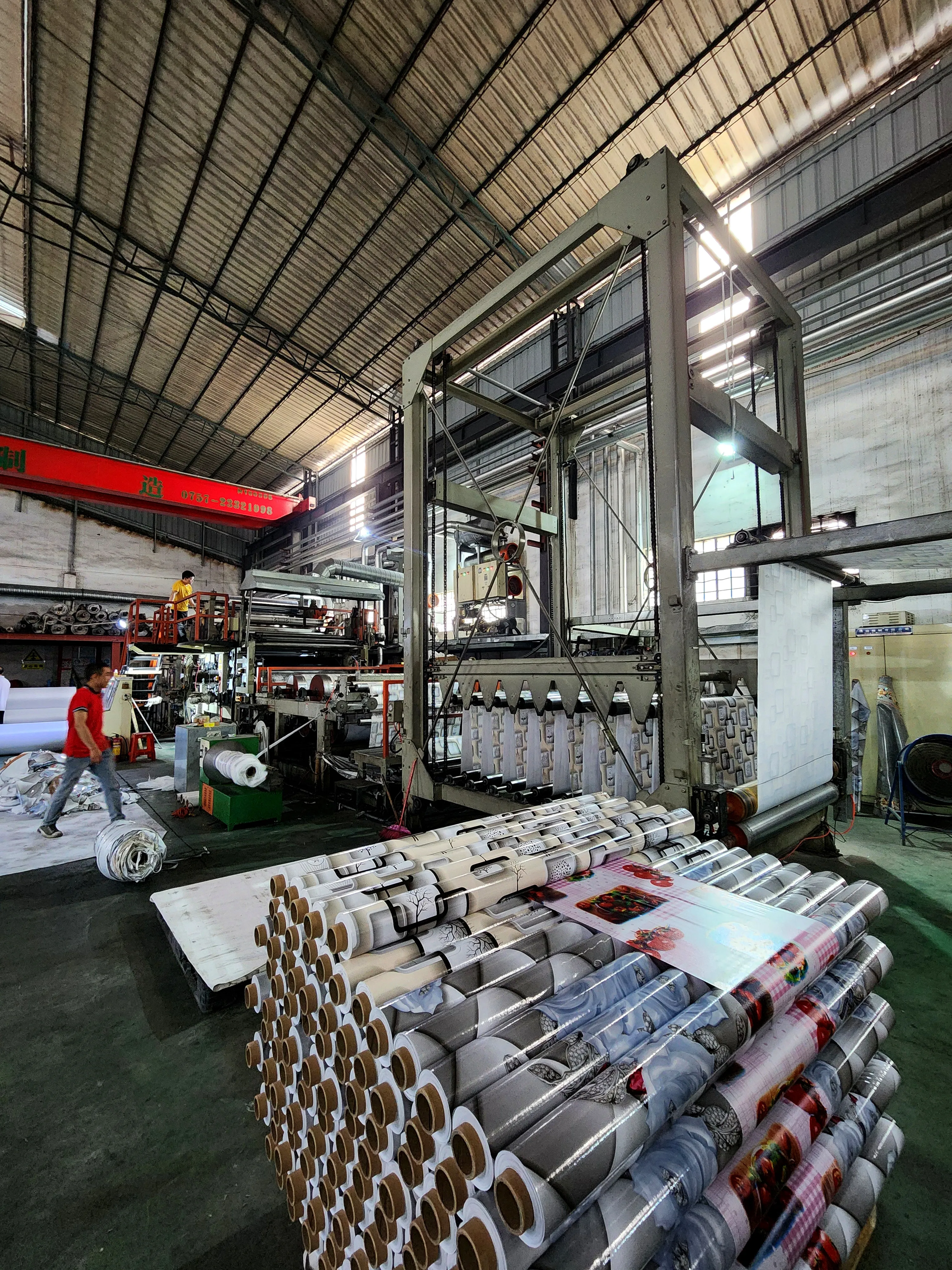 Production floor — finished rolls beside the calender line
